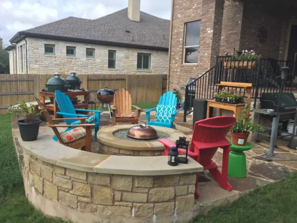 Circular stone fire pit on a flagstone patio