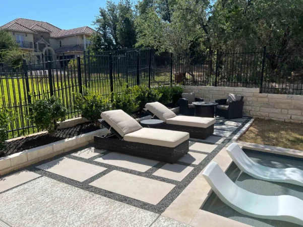 Modern poolside lounge area with geometric concrete pavers
