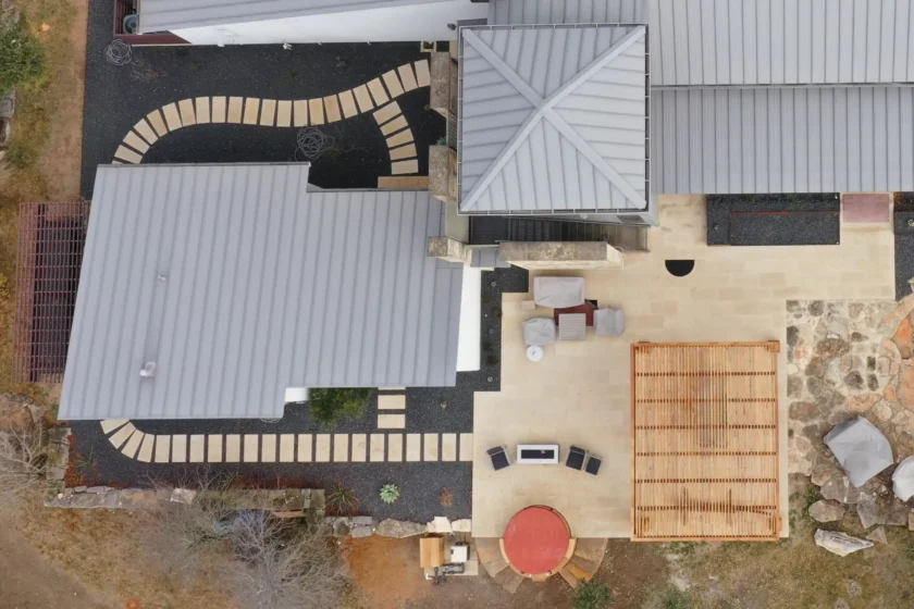 Aerial view of modern hardscape design featuring geometric paver walkways and custom patio