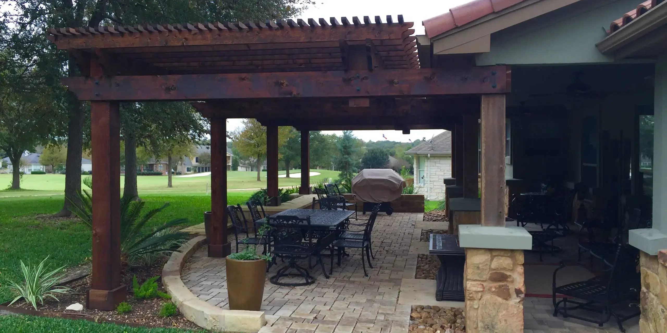 Texas outdoor patio design with custom wood pergola